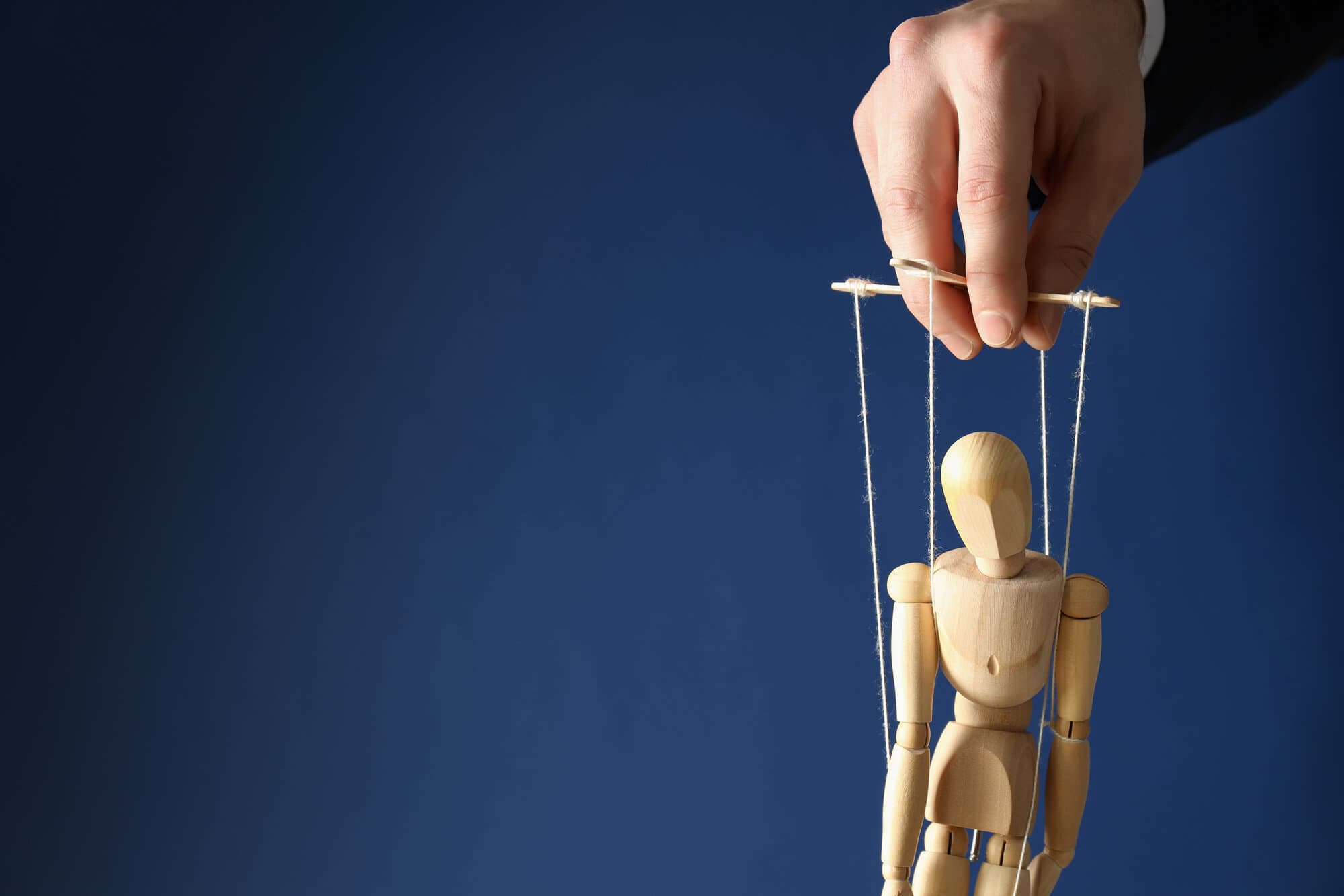 People higher on the hierarchy controlling employees, much like the hand holding the strings of the marionette puppet, results in a toxic work environment.