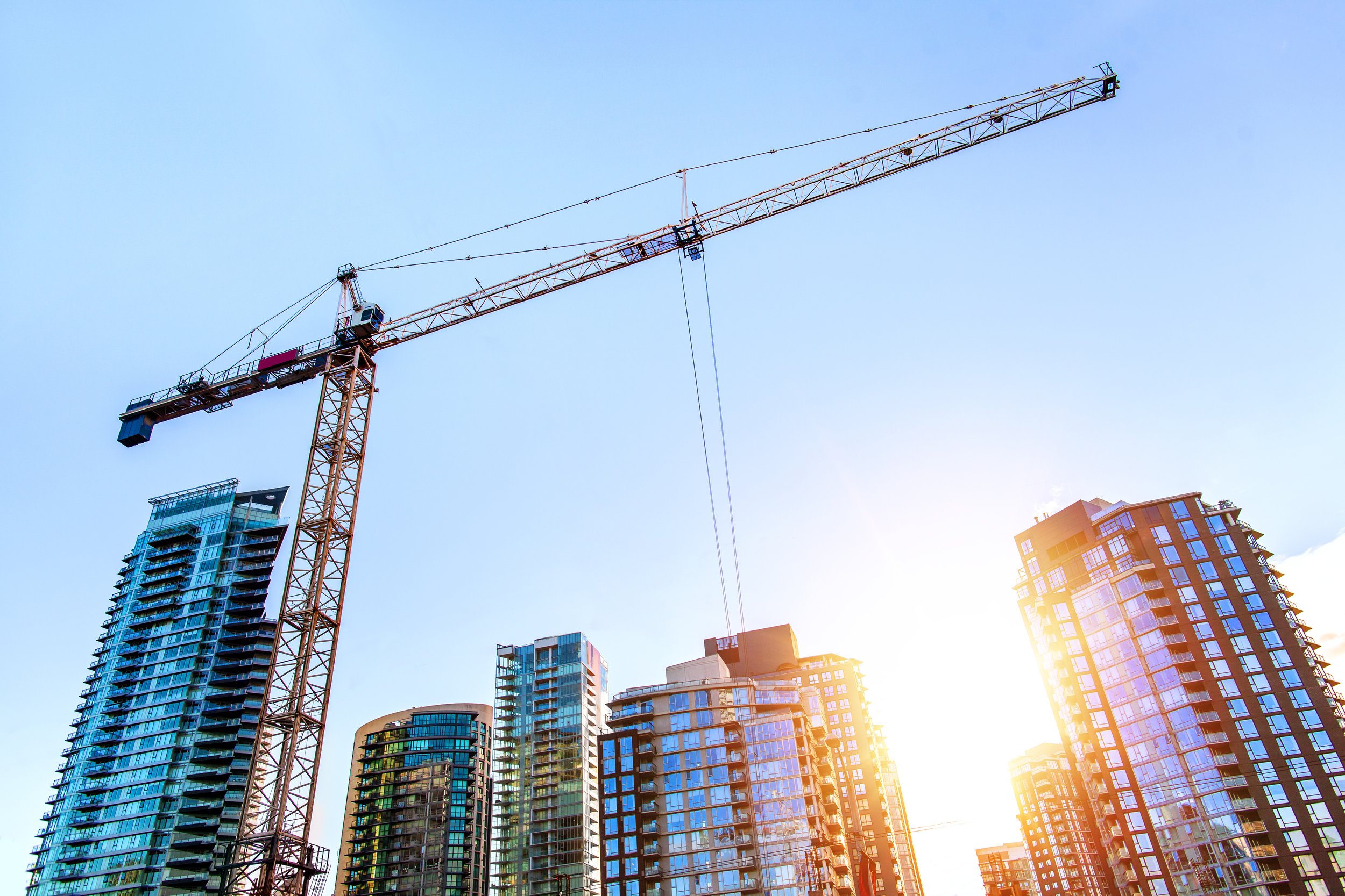 The image of a crane suspended above high-rise buildings represents an incident in the author's city in which a crane collapsed due to a lack of risk management. 
