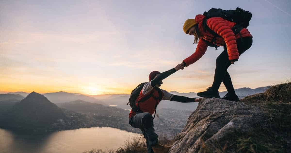 A two-person team climbing a mountain symbolizes making teamwork meaningful. 