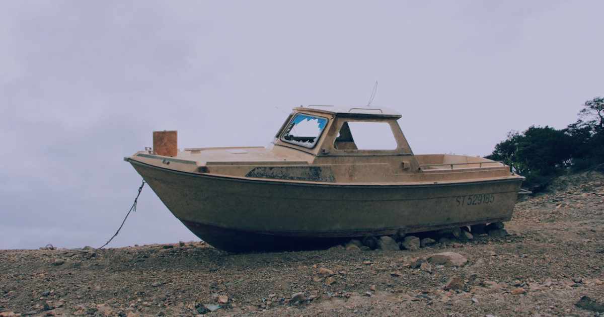 An abandoned boat symbolizes the fate of organizations that fail to address outdated systems and technical debt, illustrating the high cost of inaction.