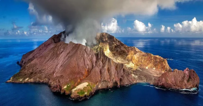 A volcano erupting with ash coming out symbolizing the dramatic and sudden nature of organizational transformations, often seen as forceful but not always sustainable, contrasting with the gradual, steady approach of adaptation.