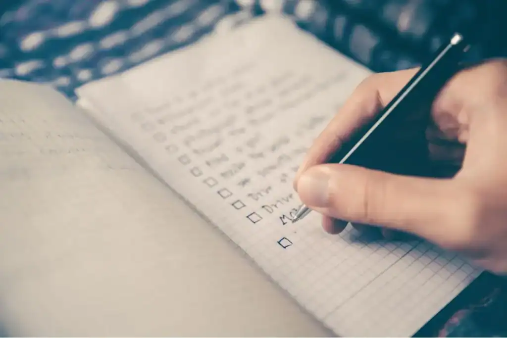 A person filling a task list as part of a process