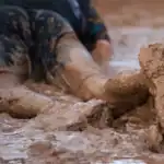 man stuck in mud much like organizations refusing to change