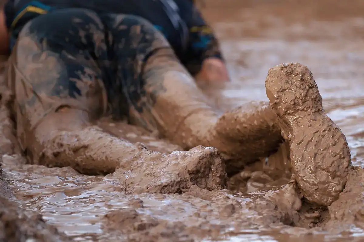 man stuck in mud much like organizations refusing to change
